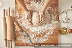 Woman forming dough into ball on bread board 5p8JA5