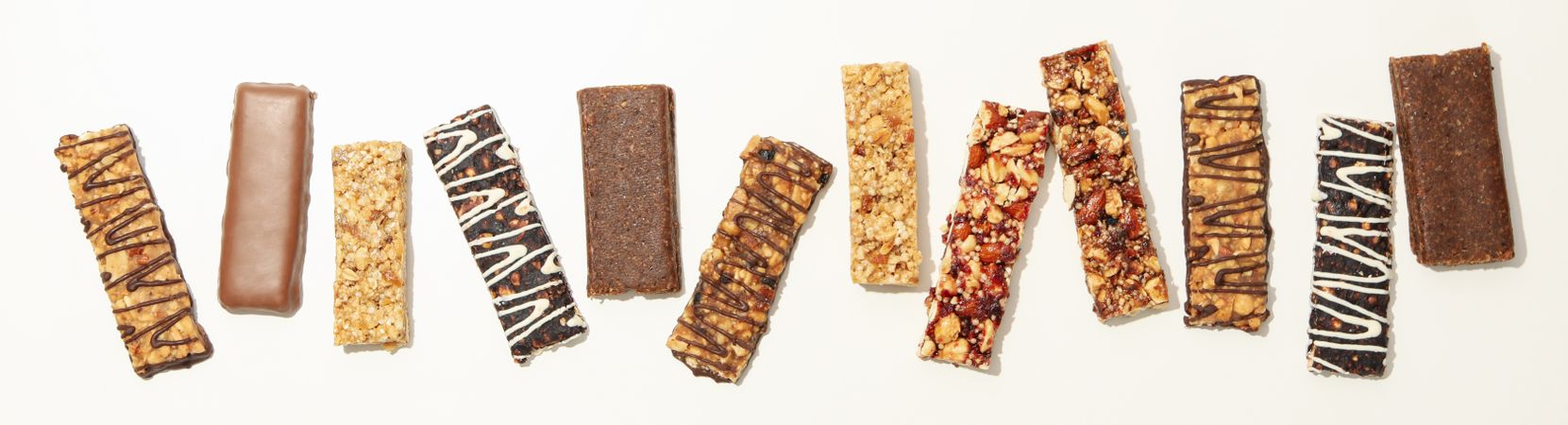 Tasty granola bars on neutral background, top view
