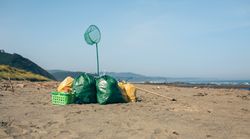 Garbage bags and utensils on the beach