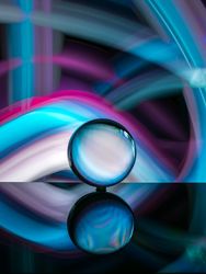 Crystal ball on board near abstract shines