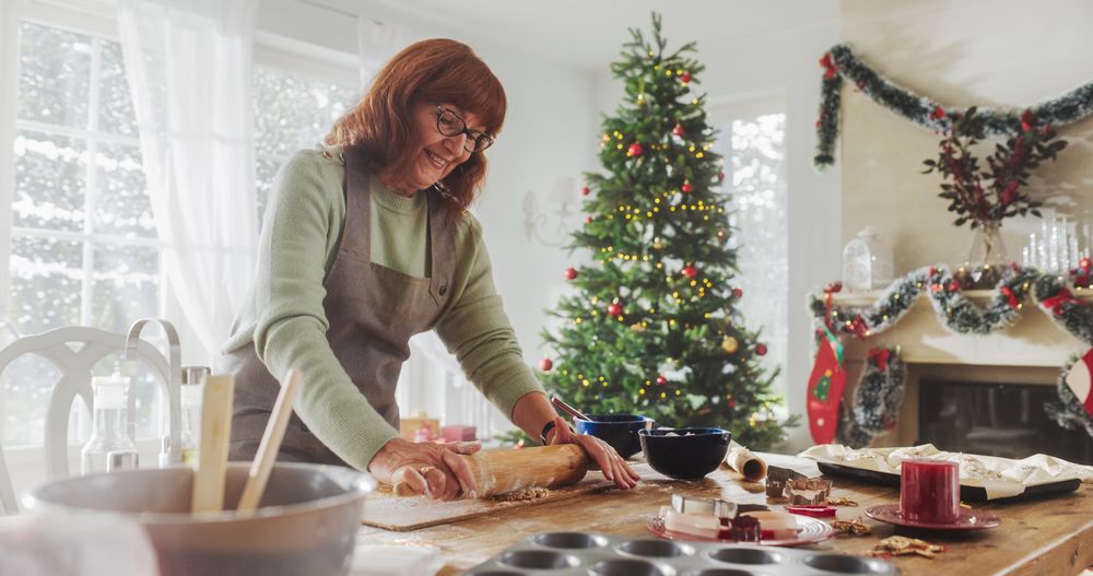 Portrait of Mature Female Preparing Dough for Making Gingerbread for Christmas at Home.