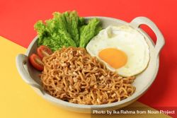 Indomie goreng, Indonesian noodles and egg on duotone background bD9By0