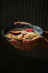 Crop female with portion of ramen under sunlight