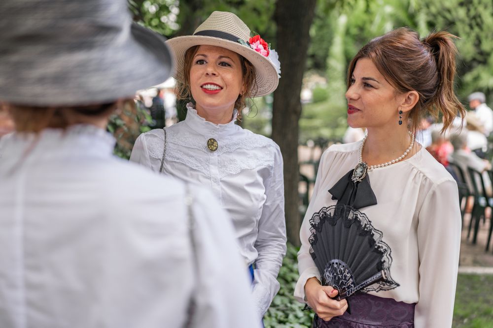 Vintage female friends speaking in garden