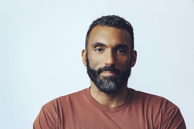 Head shot of calm Black male in grey studio