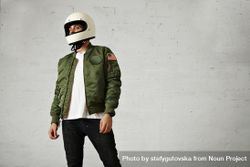 Man in green jacket wearing biker helmet in studio shoot 4MzLlb
