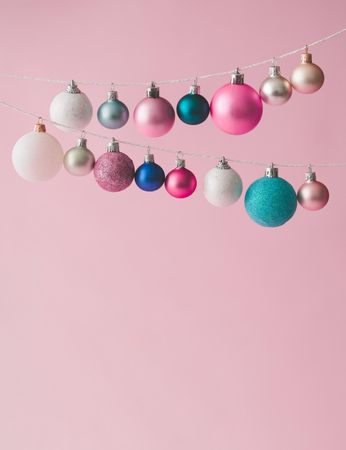 Colorful pastel Christmas decoration balls on pink background