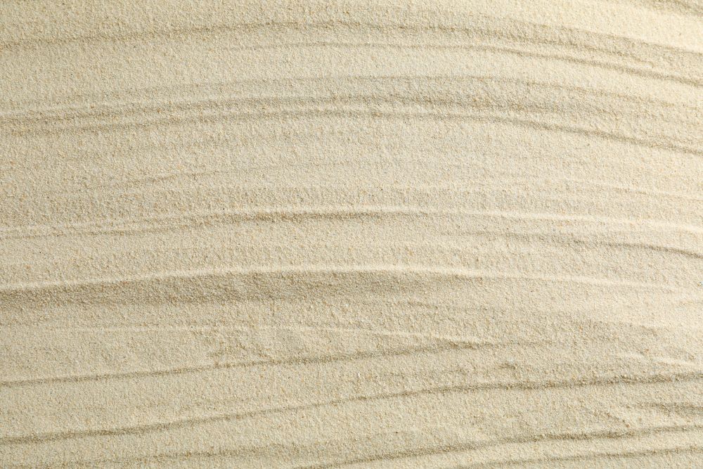 Clear sea sand as background, space for text and closeup. Summer vacation background