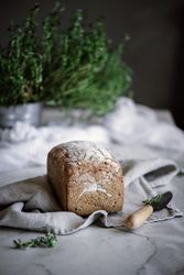 Fresh bread on napkin near tomatoes jam