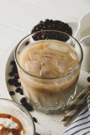 Composition with tray with ice coffee on wooden background