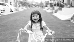 Monochrome photo of girl riding a bicycle on the street 4Nlge0