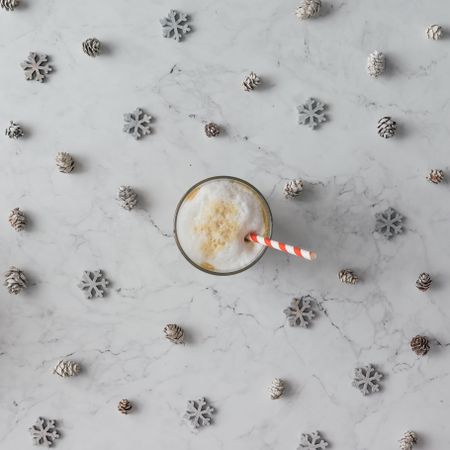 Snowflakes and pinecones on marble background with coffee