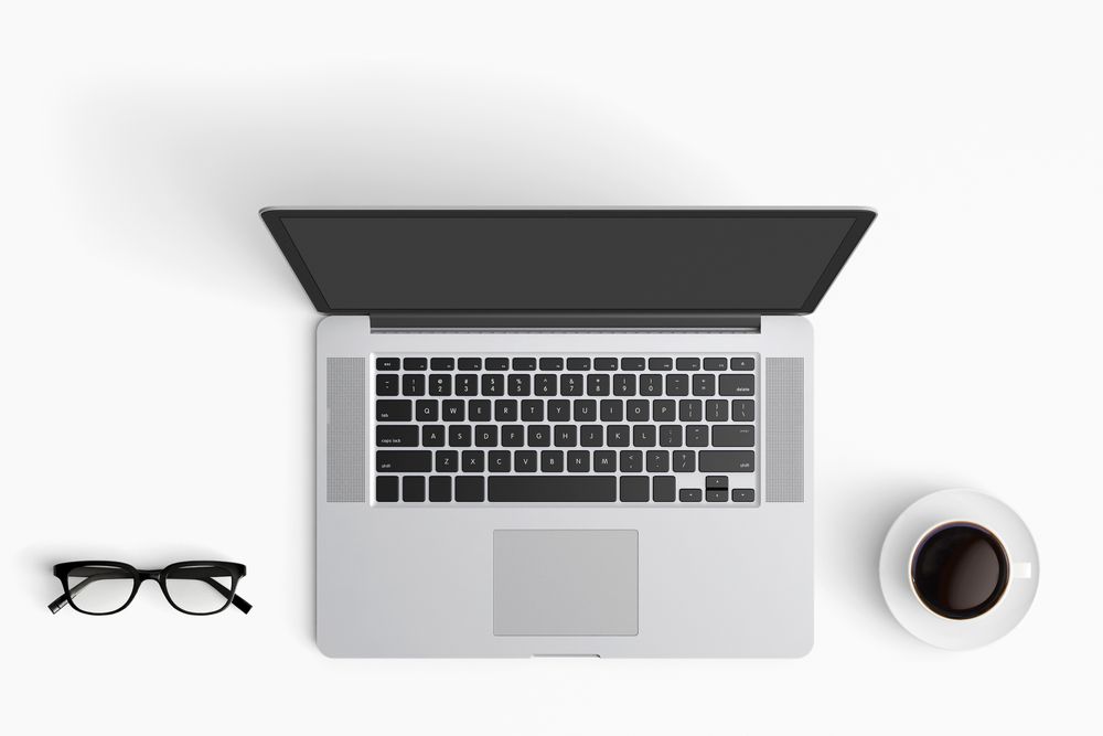 Modern workspace with coffee cup, smartphone, paper, notebook, tablet and laptop copy space