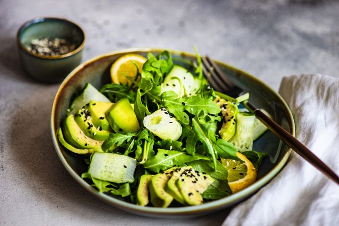 Close up of healthy vegetable salad with arugula and avocado