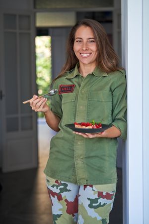 Cheerful young woman with strawberry cake
