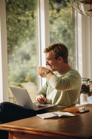 Man enjoying coffee while working from home