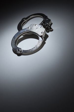 Abstract Pair of Handcuffs Under Spot Light - Text Room