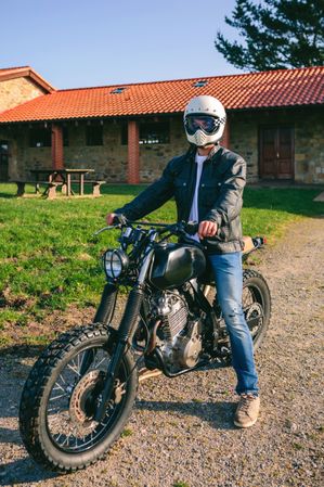 Man with helmet riding custom motorbike