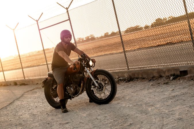 Strong man driving motorcycle