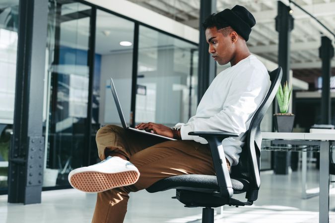 Creative businessman sitting alone in a modern workplace