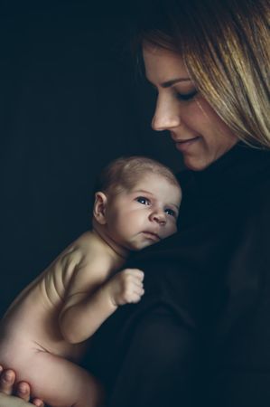 Baby posing in her mother's arms