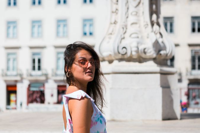 stylish woman in sunglasses sitting in street stairs