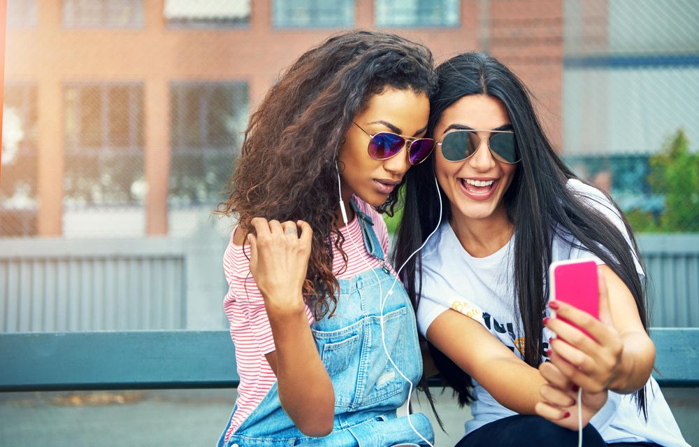 Happy women taking selfie outdoors