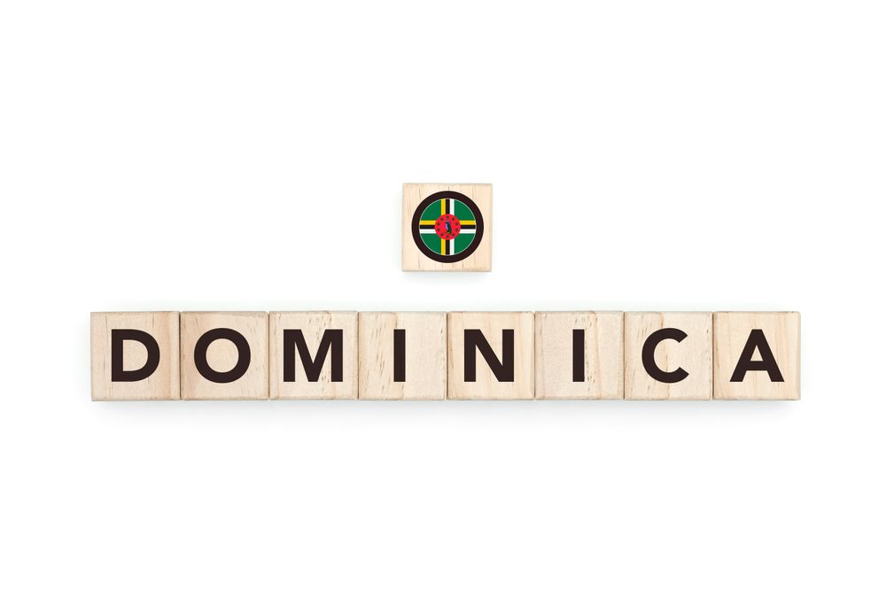 Wooden blocks bearing the name and flag of Dominica. Dominican and Caribbean Culture, national identity, travel, and geography in a copy space design.