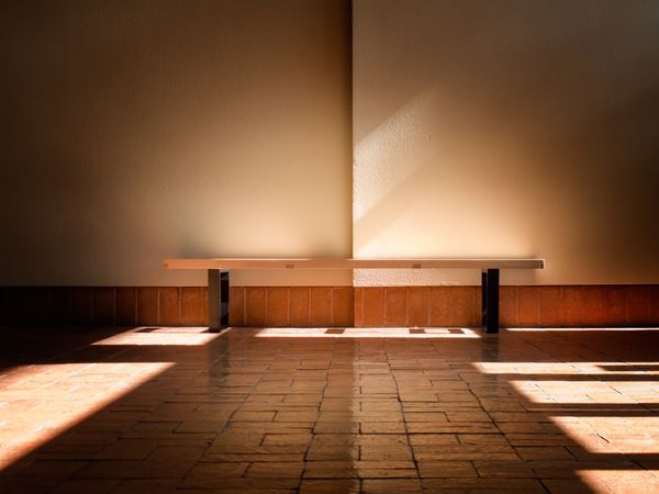 Empty bench in sunbeam indoors