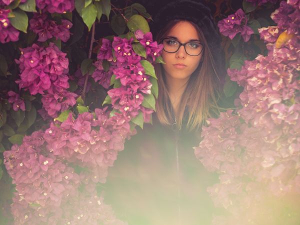 Woman on background of stunning violet flowers
