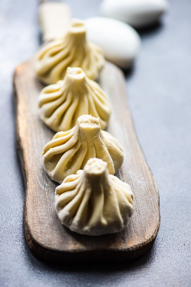 Traditional Georgian khinkali dumplings served on wooden board