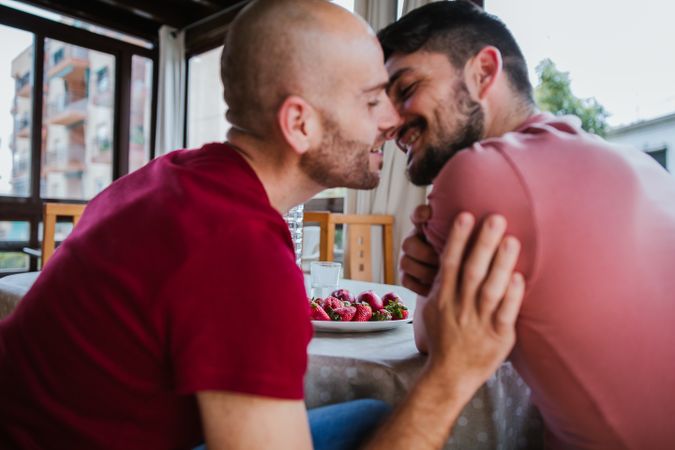 Gay couple eating strawberries