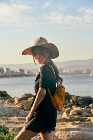 Woman traveler in straw hat walking