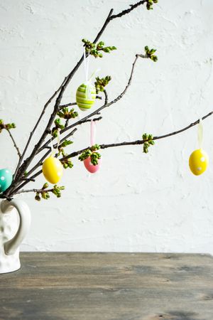 Decorative Easter eggs on branch in vase
