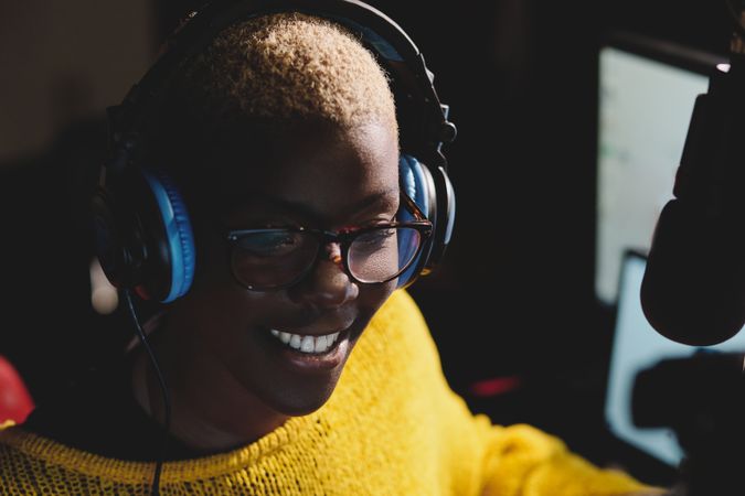 Smiling Black female radio host in studio