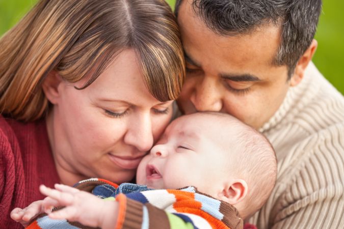 Happy Family Posing for A Portrait in the Park