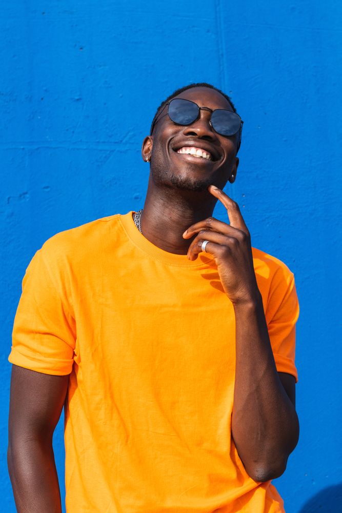 Black man in bright sporty outfit and sunglasses