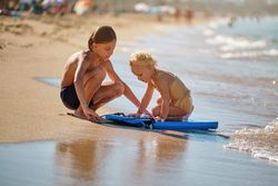 Children playing on sandy beach