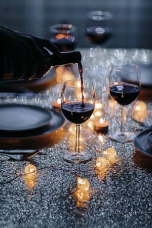 Wine being poured into glass at holiday table