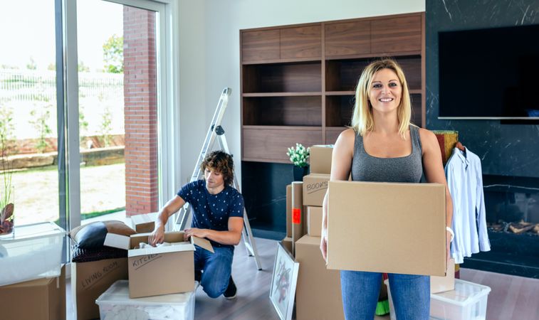 Woman carrying moving box