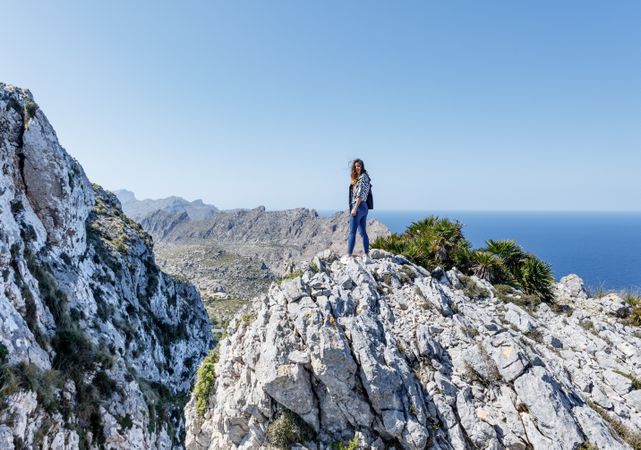 Young woman standing on cliff