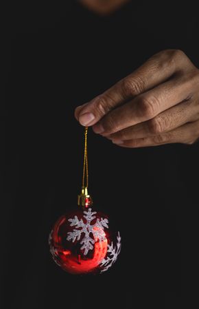 Crop person showing Christmas baubles