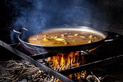 Process of cooking paella on fire