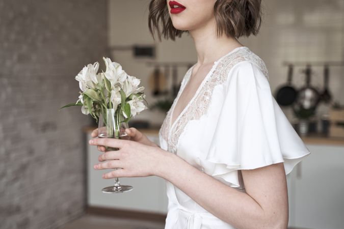 woman with red lips holding white flowers and dreaming