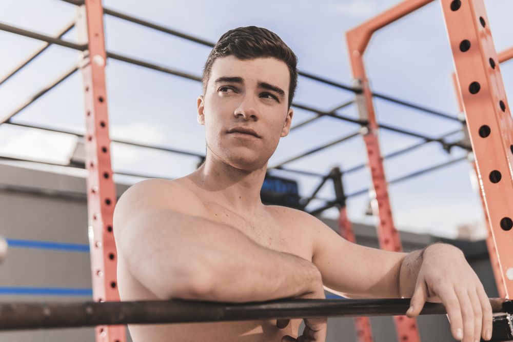 Shirtless man on sports ground
