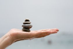 Pile of small rocks on person's hand