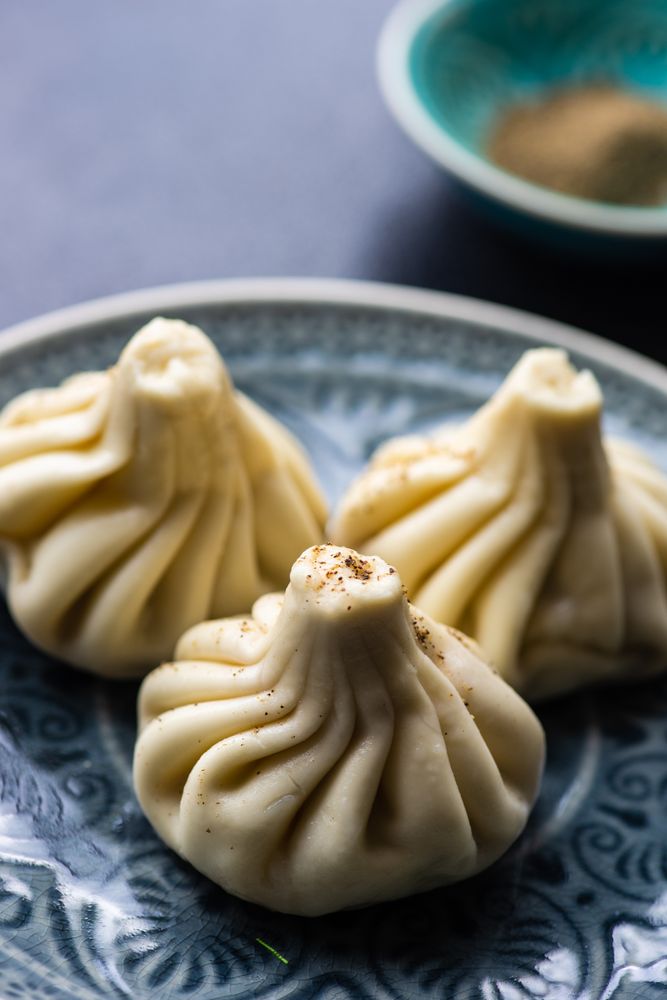 Close up of tops of three Georgian khinkali dumplings