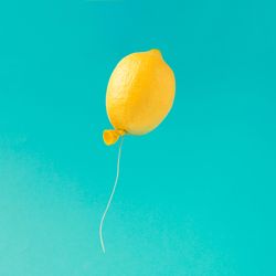 Lemon balloon on bright blue background