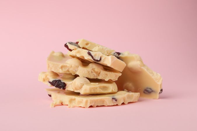chocolate pieces on pink background. Sweet food