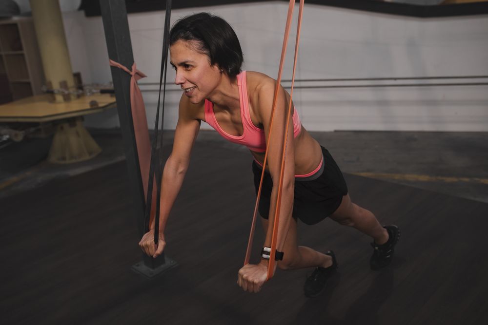 Athletic young woman training in gym